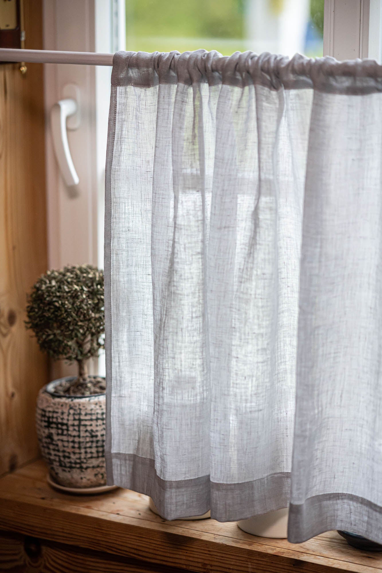 Sheer linen cafe curtain in rainy day