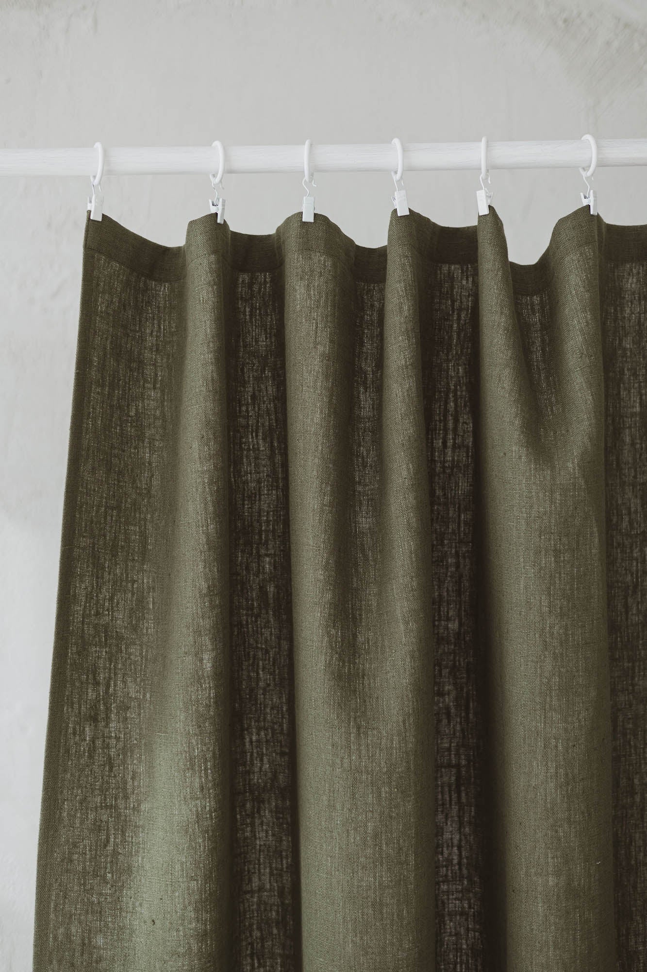 Heavyweight forest green linen curtain with simple hem, for clips
