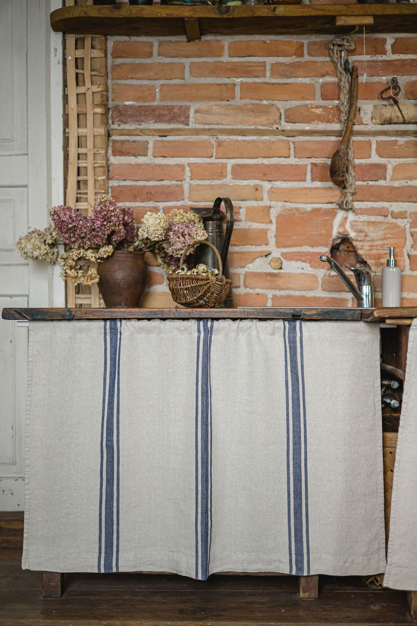 Linen cabinet curtain with blue stripes