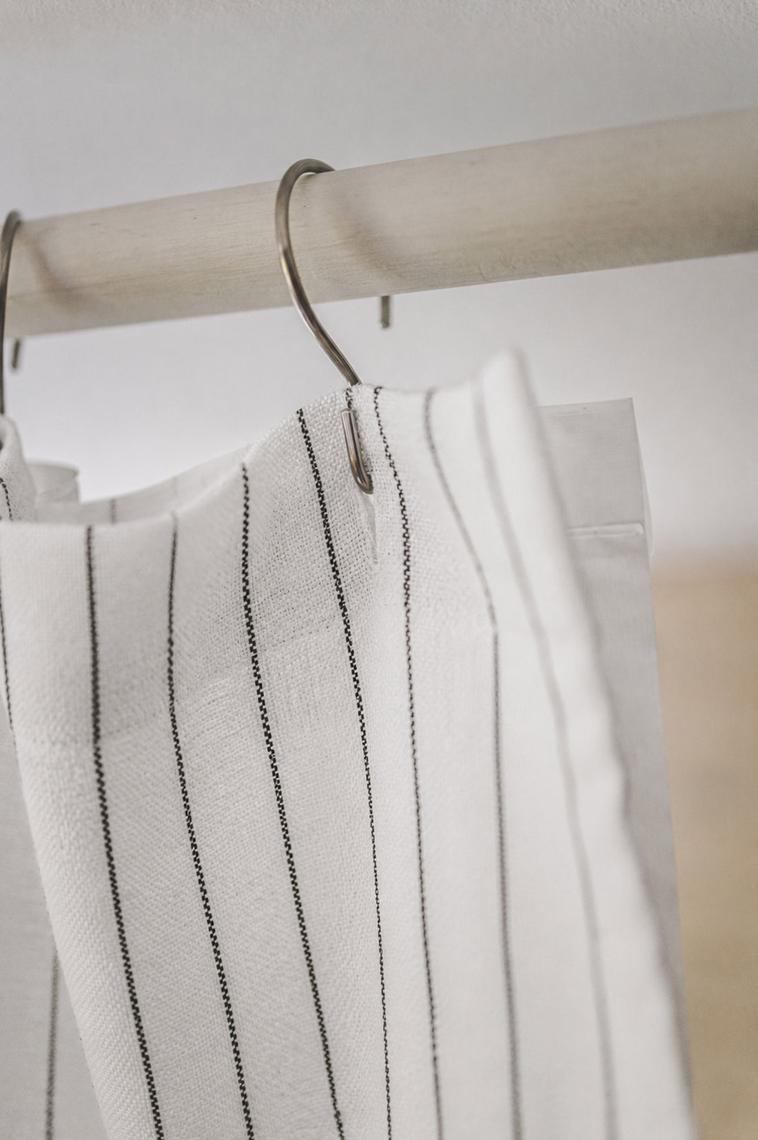 White linen shower curtain with black stripes