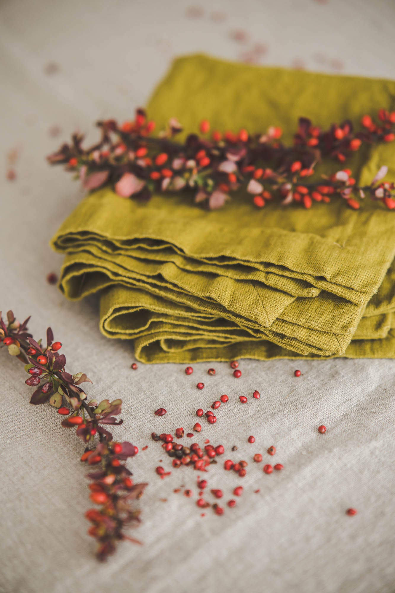 Olive green linen napkins with mitered corners