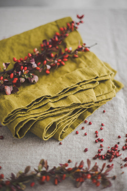 Olive green linen napkins with mitered corners