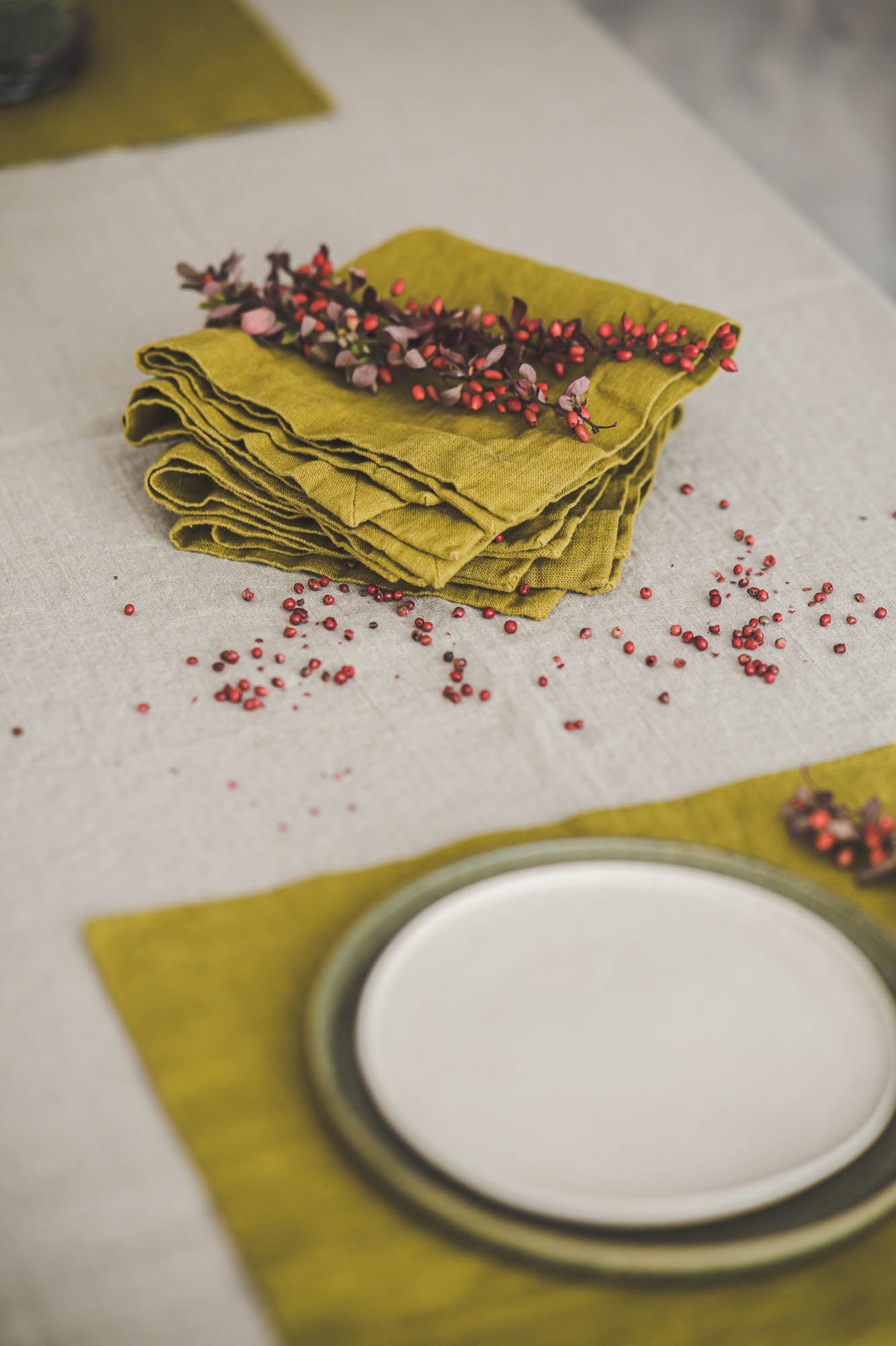 Olive green linen napkins with mitered corners