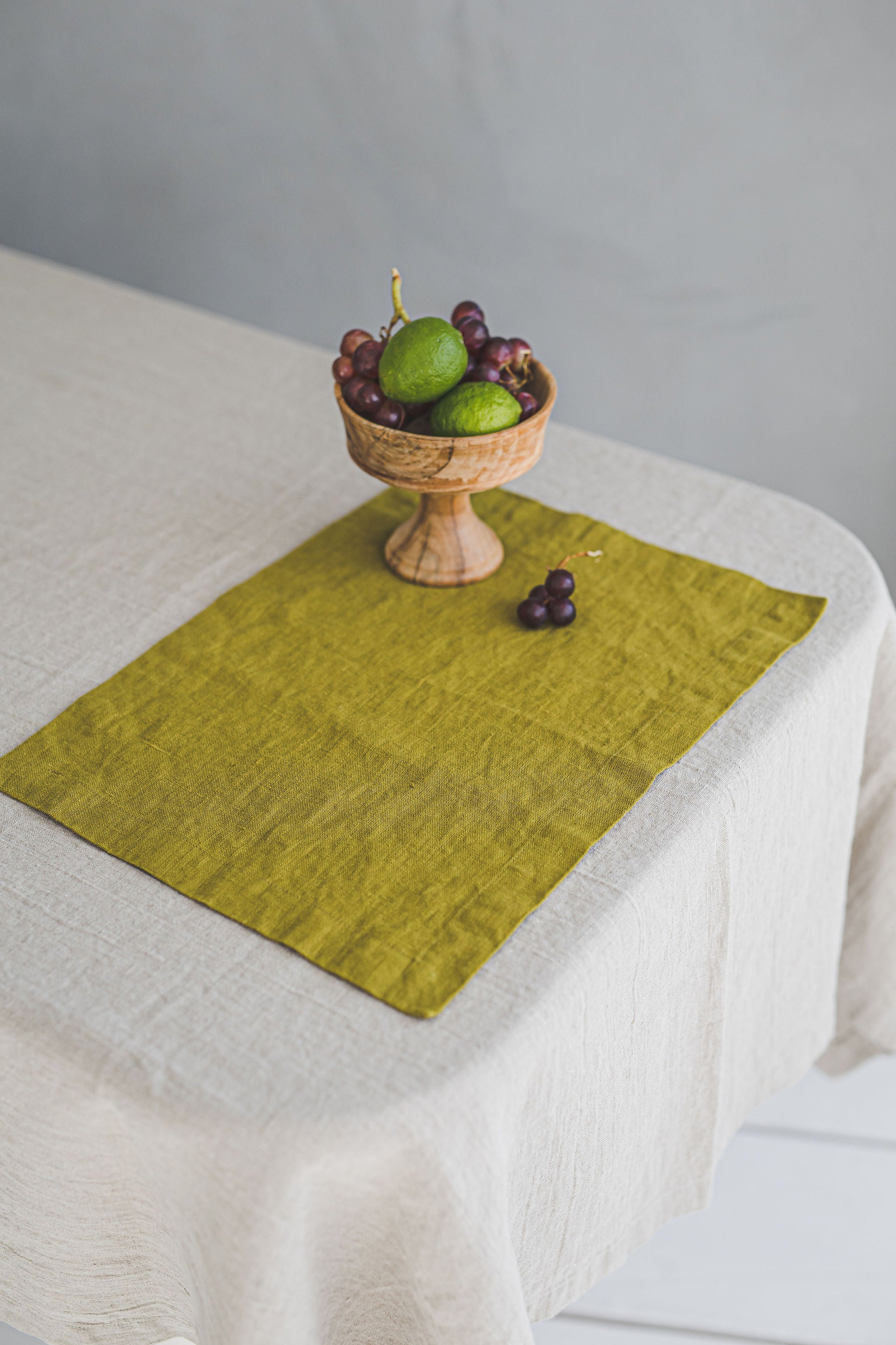 Olive green linen placemats with mitered corners