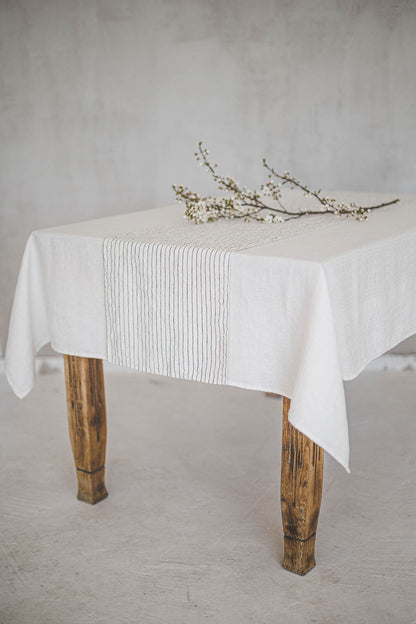 White linen table runner with black stripes