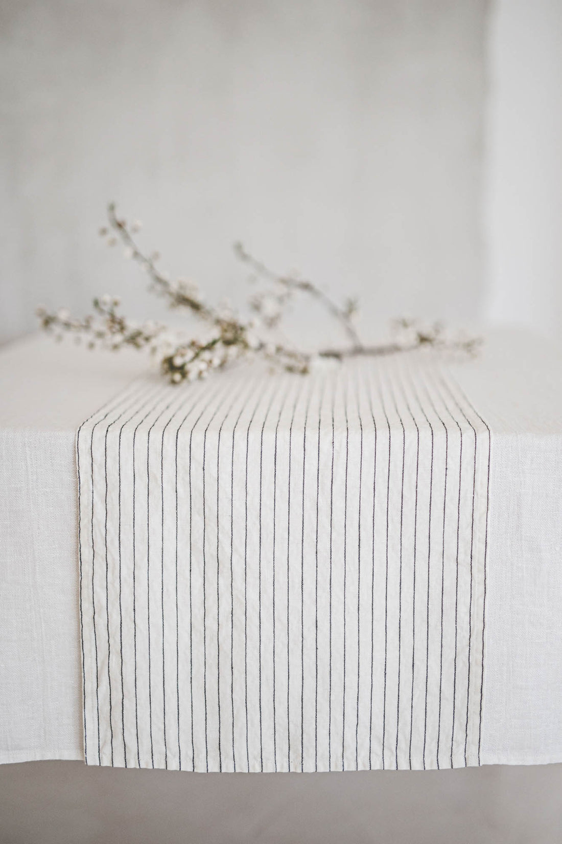 White linen table runner with black stripes