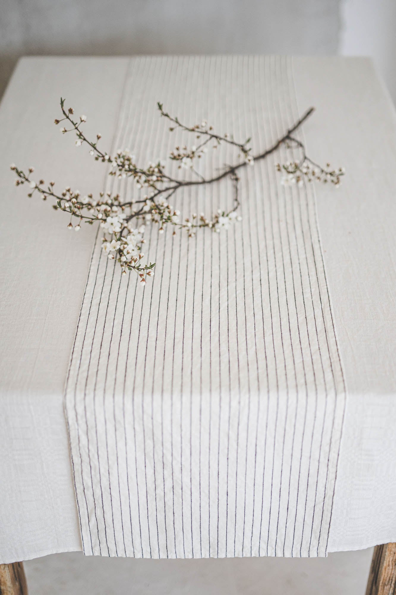 White linen table runner with black stripes