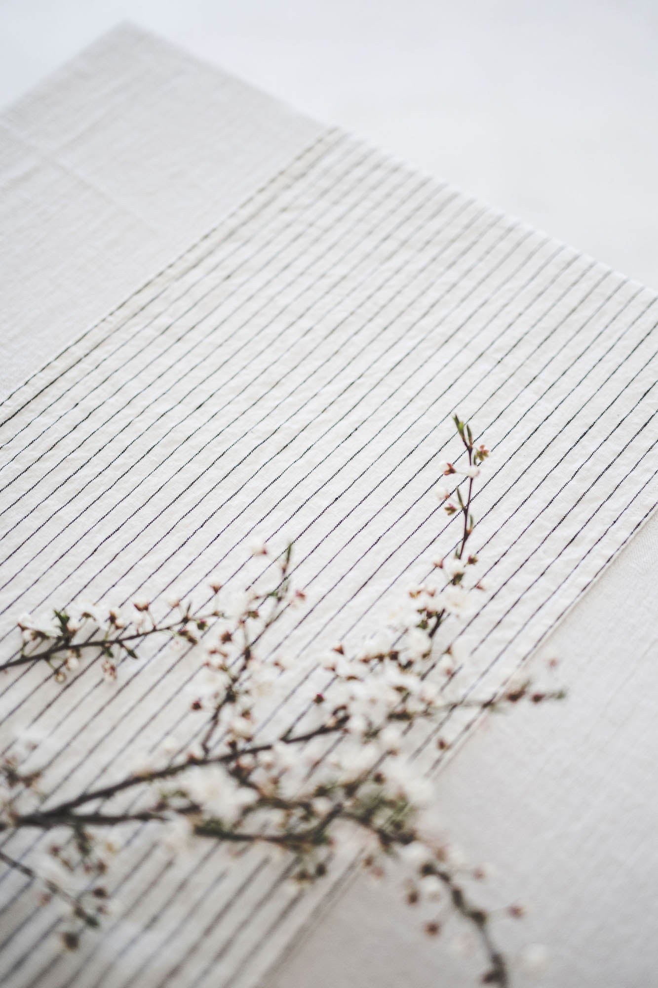 White linen table runner with black stripes